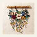 Crochet floral wall hanging with layered flowers and lily of the valley strands
