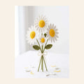 Crochet white daisy bouquet with yellow centres tied with a bow