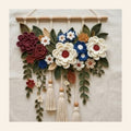 Crochet floral wall hanging with cream and maroon flowers and three tassels