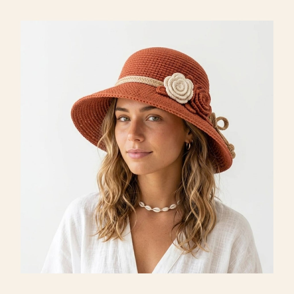 Crochet bucket hat in terracotta paper raffia with a cream flower band