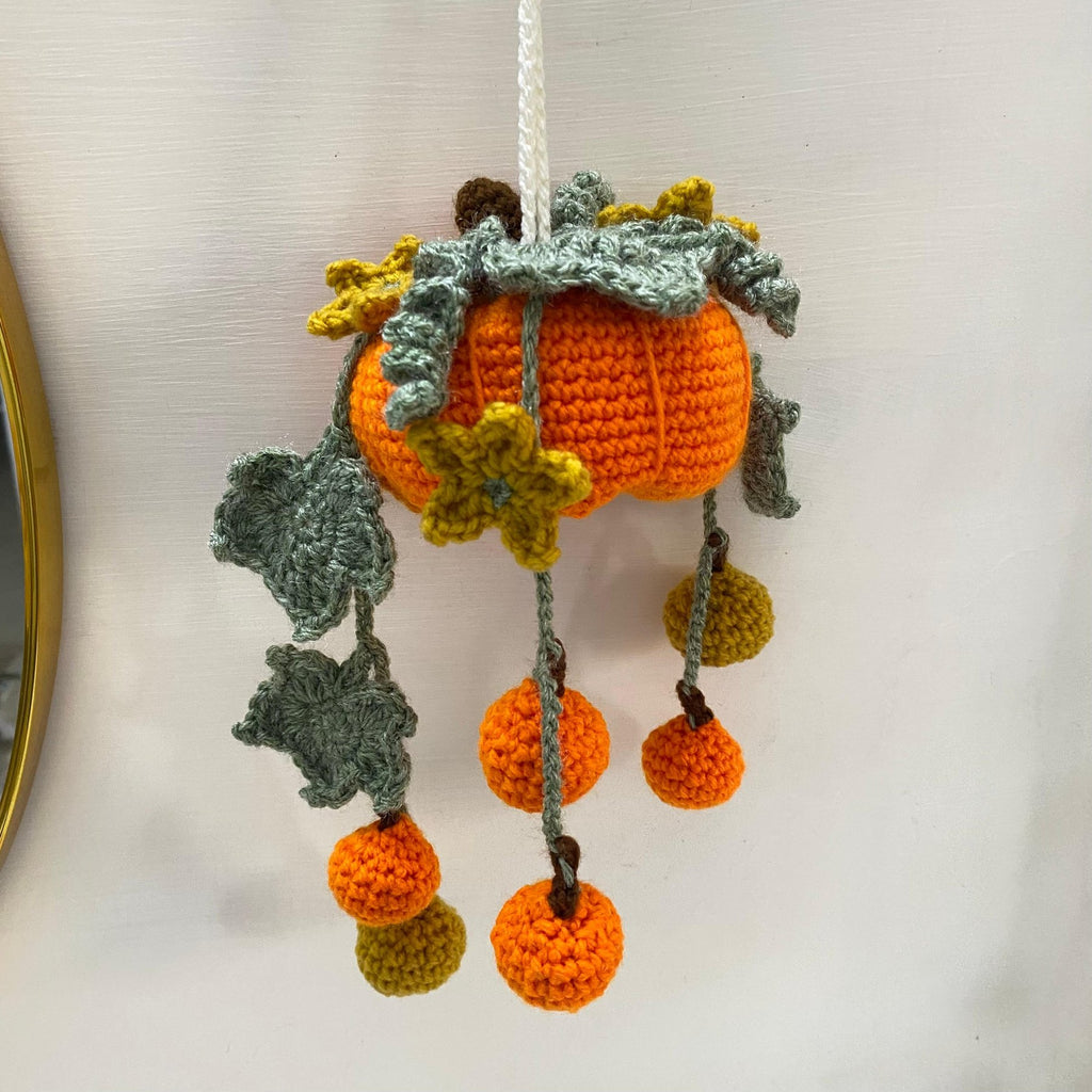 Crochet hanging pumpkin with mini pumpkins, leaves and flowers on green vines
