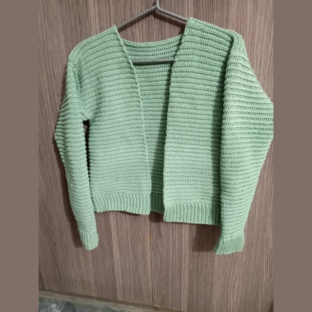 Oversized green crochet rib stitch cardigan on a hanger, front view