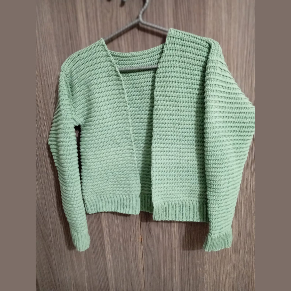 Close view of the ribbed texture on the green crochet cardigan