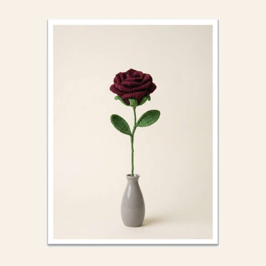 Deep red crochet rose with green leaves in a small grey vase