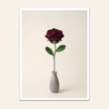 Deep red crochet rose with green leaves in a small grey vase
