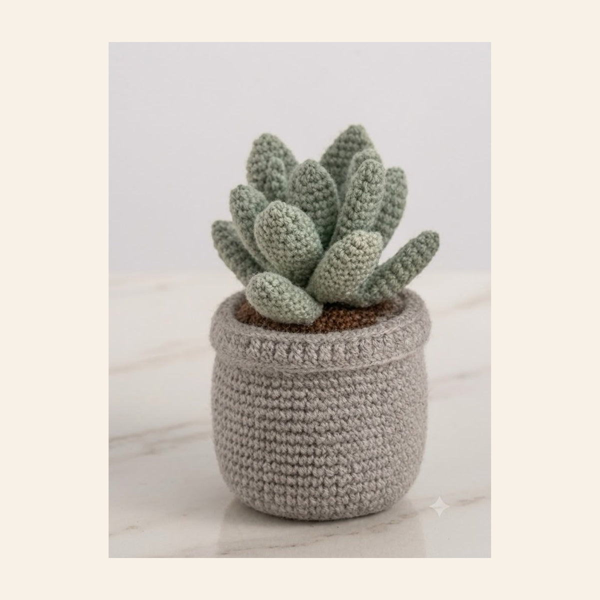 Crochet succulent with pale green leaves in a grey crochet pot